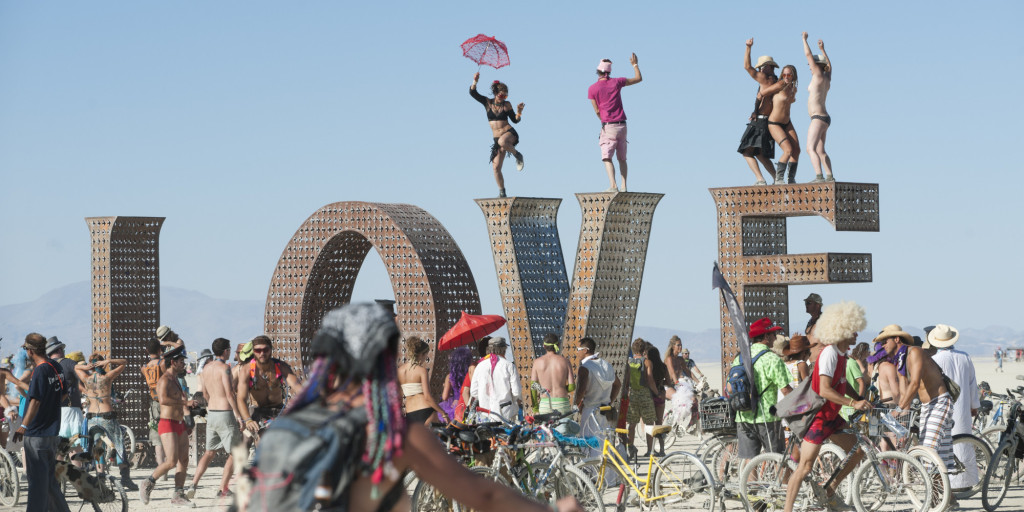 BLACK ROCK CITY, NV - SEPT 2: First-time Burner Sonja Lercer of Whistler, B.C., Canada, dances on the LOVE installation at last week's 25th annual Burning Man festival.   (Photo by Keith Carlsen For the Washington Post)